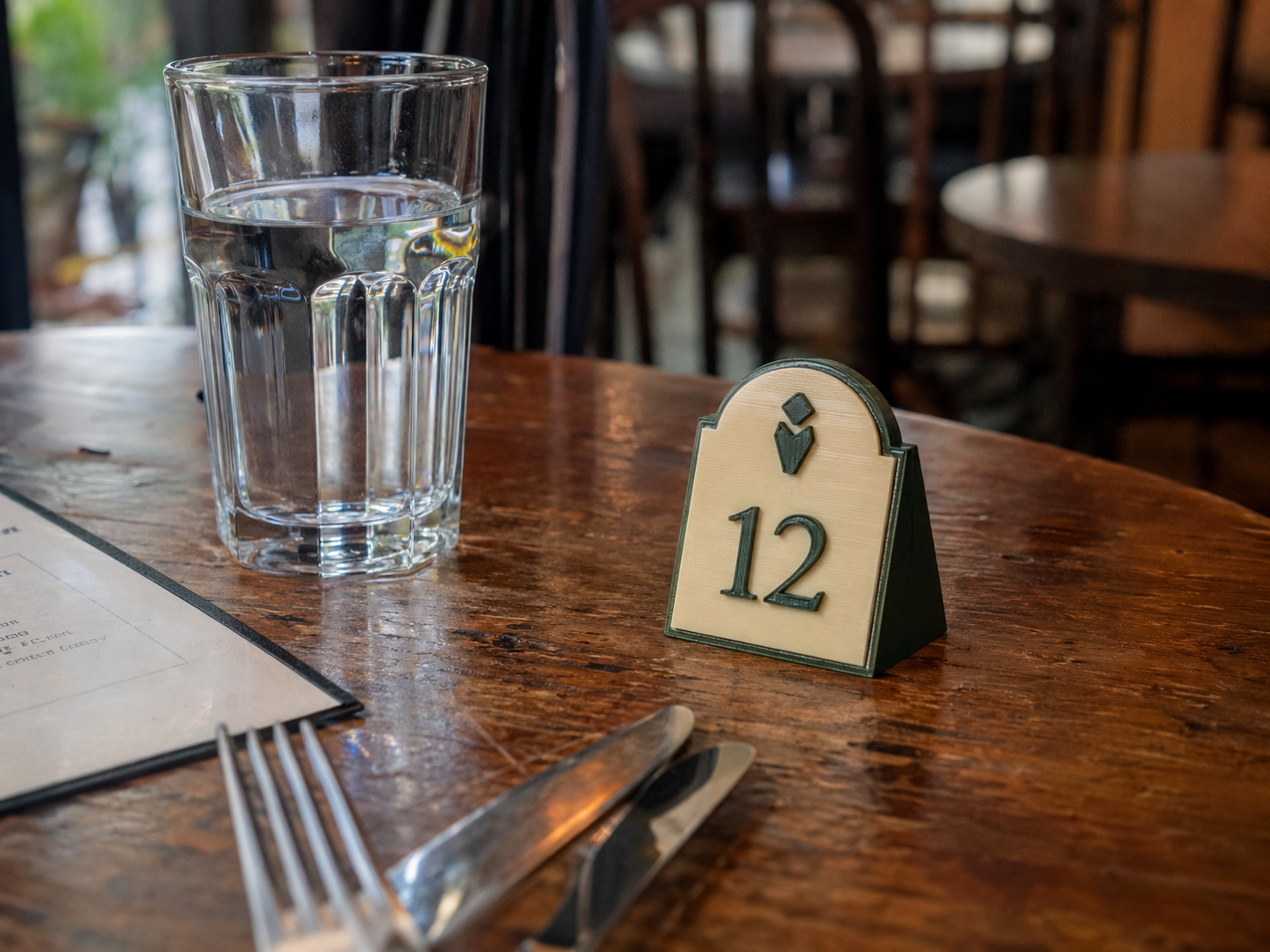 Small 3D-printed table number in a café